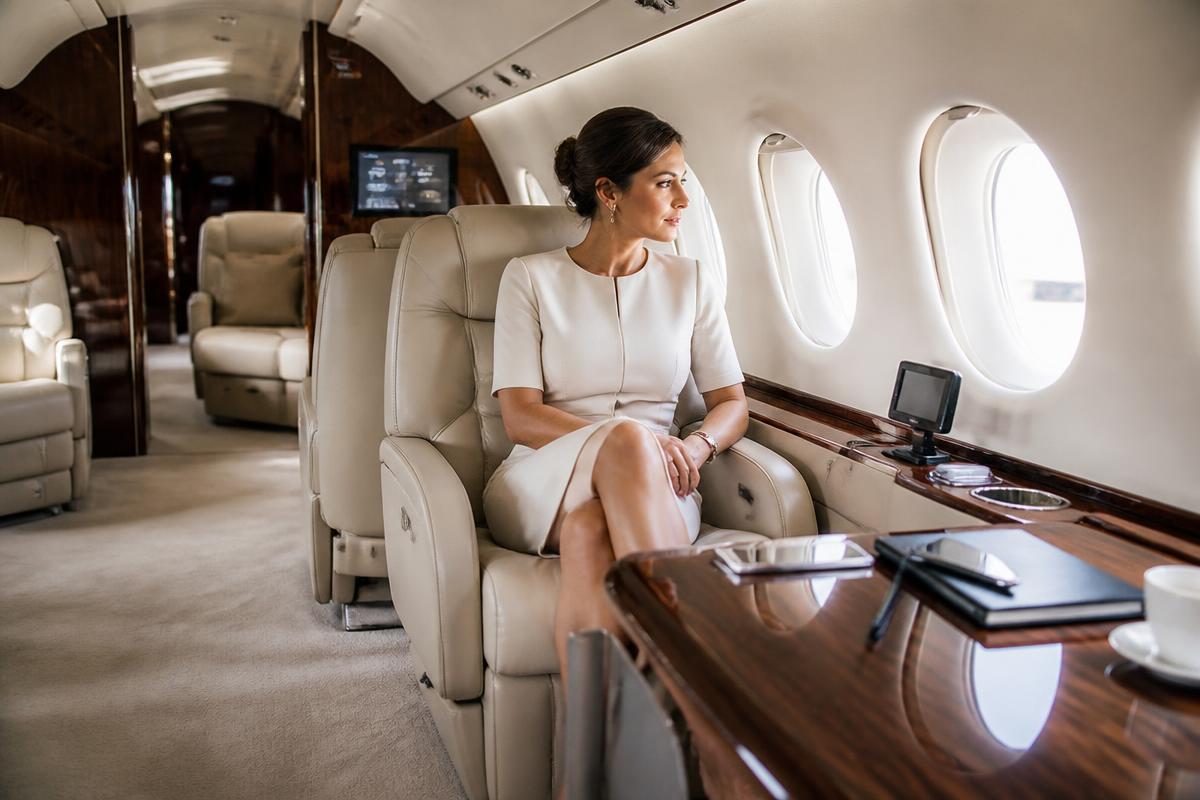 Midsize private jet cabin with cream leather seating